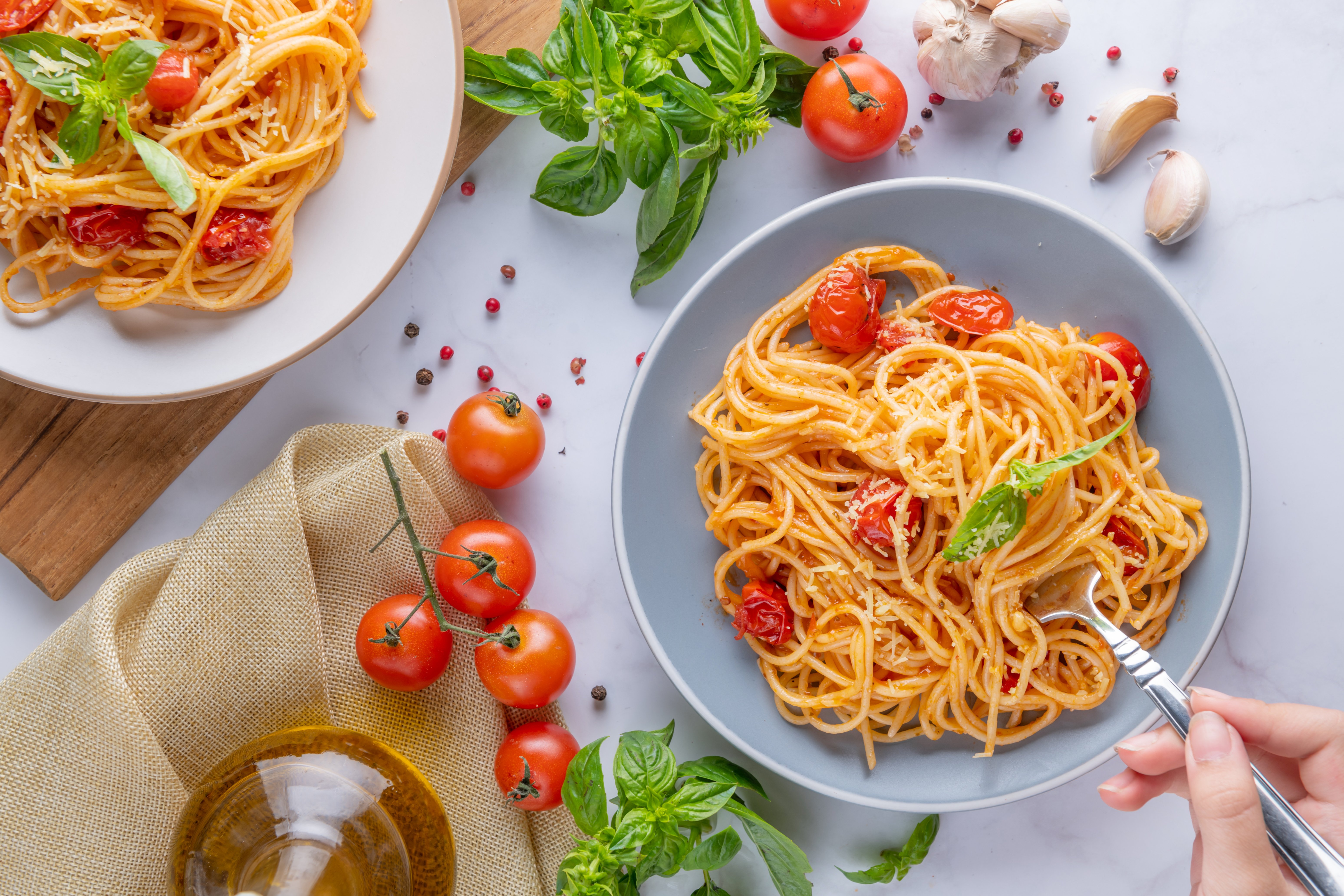 tasty-appetizing-classic-italian-spaghetti-pasta-with-tomato-sauce-cheese-parmesan-basil-plate-ingredients-cooking-pasta-white-marble-table-flat-lay-top-view-copy-space
