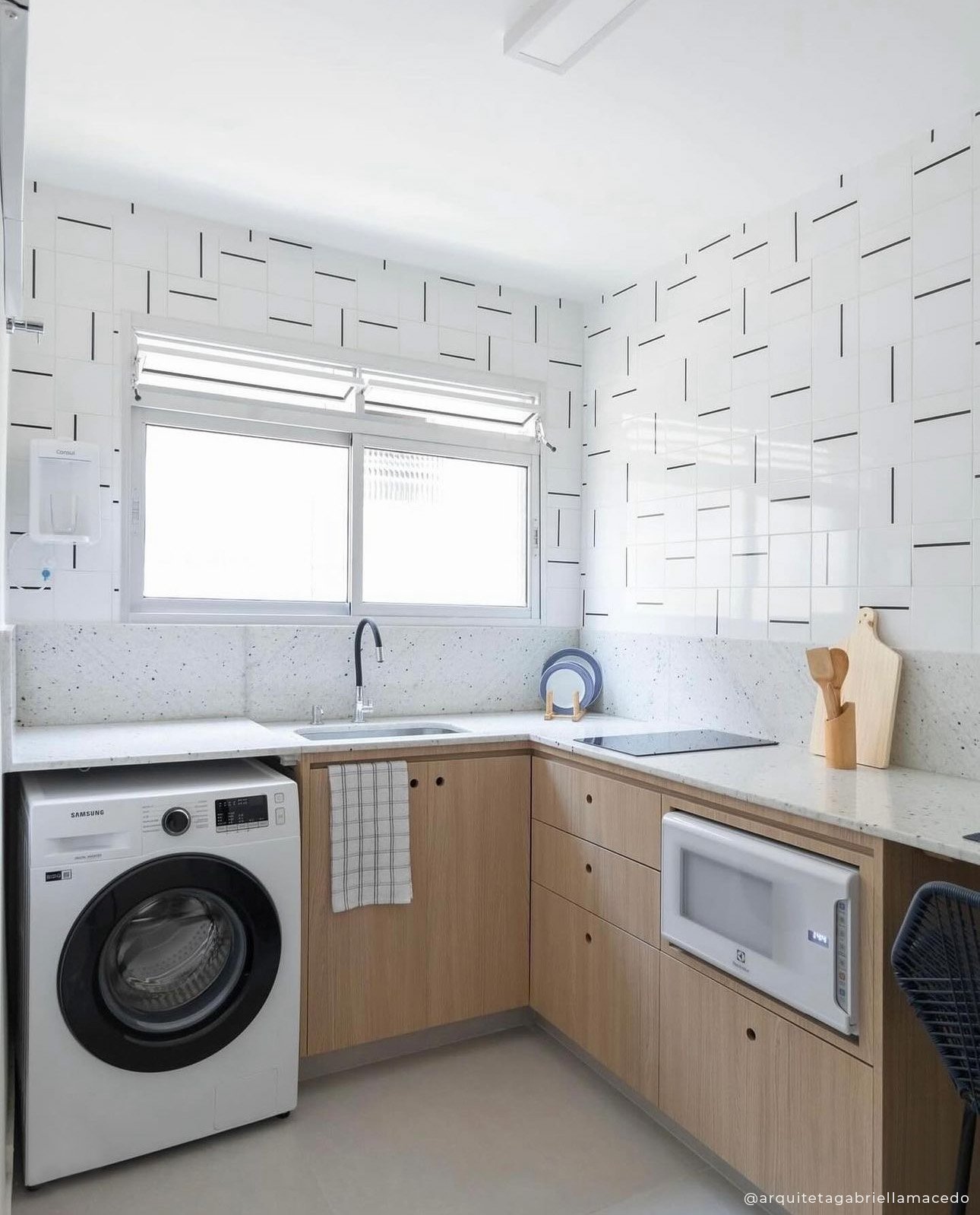 Lavanderia integrada com azulejos de design autoral em linhas pretas
